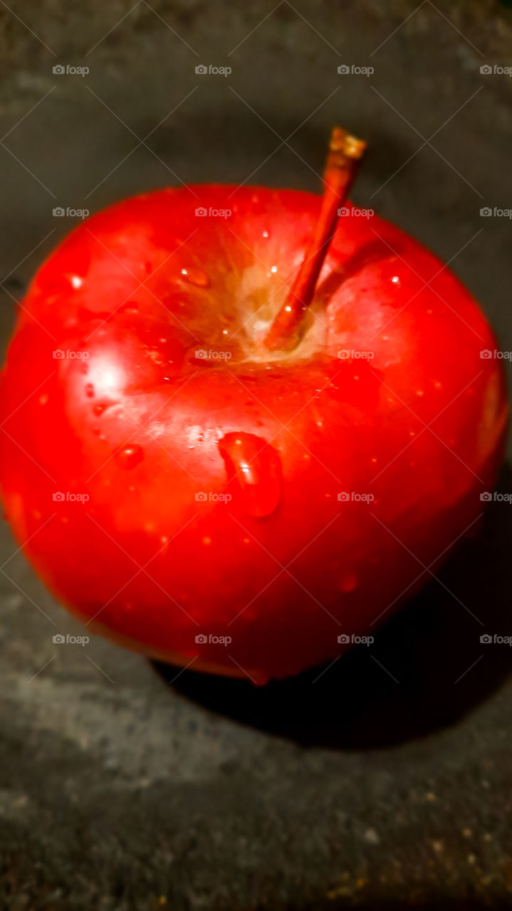 A red apple with water drops