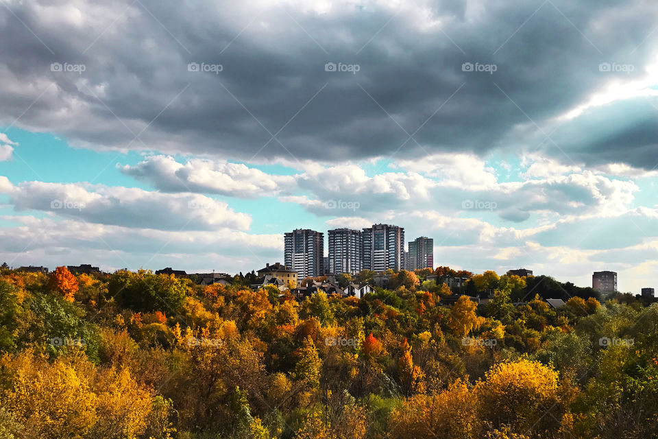 Beautiful autumn with cloudy sky in the city surrounded by the countryside 