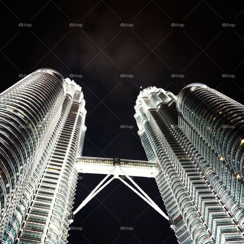 Petronas Twin Tower. Looking up these towers at night in Kuala Lumpur, Malaysia reveals a magnificent view. 