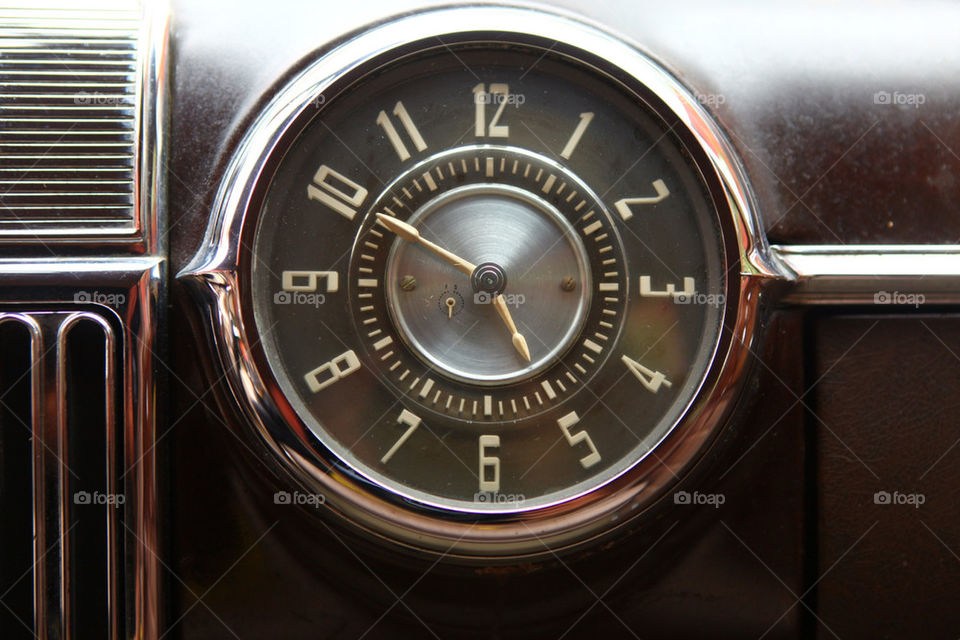 Old style art deco clock on vintage Cadillac dashboard