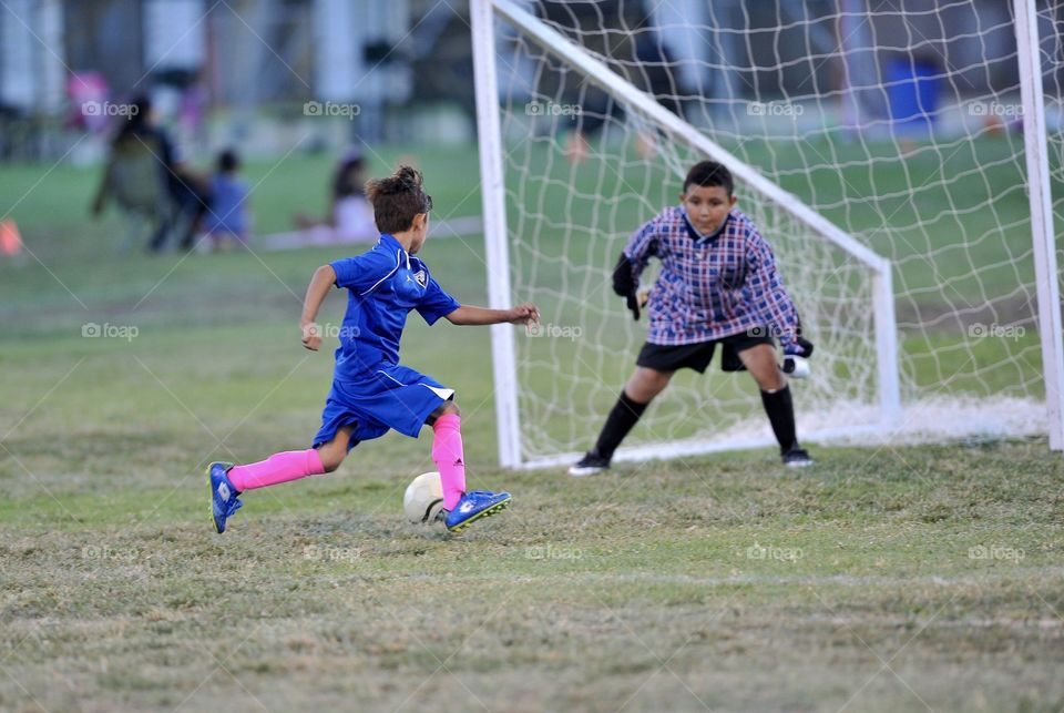 soccer kid about to score goal