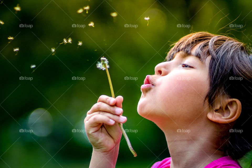 Cute girl and dandelion