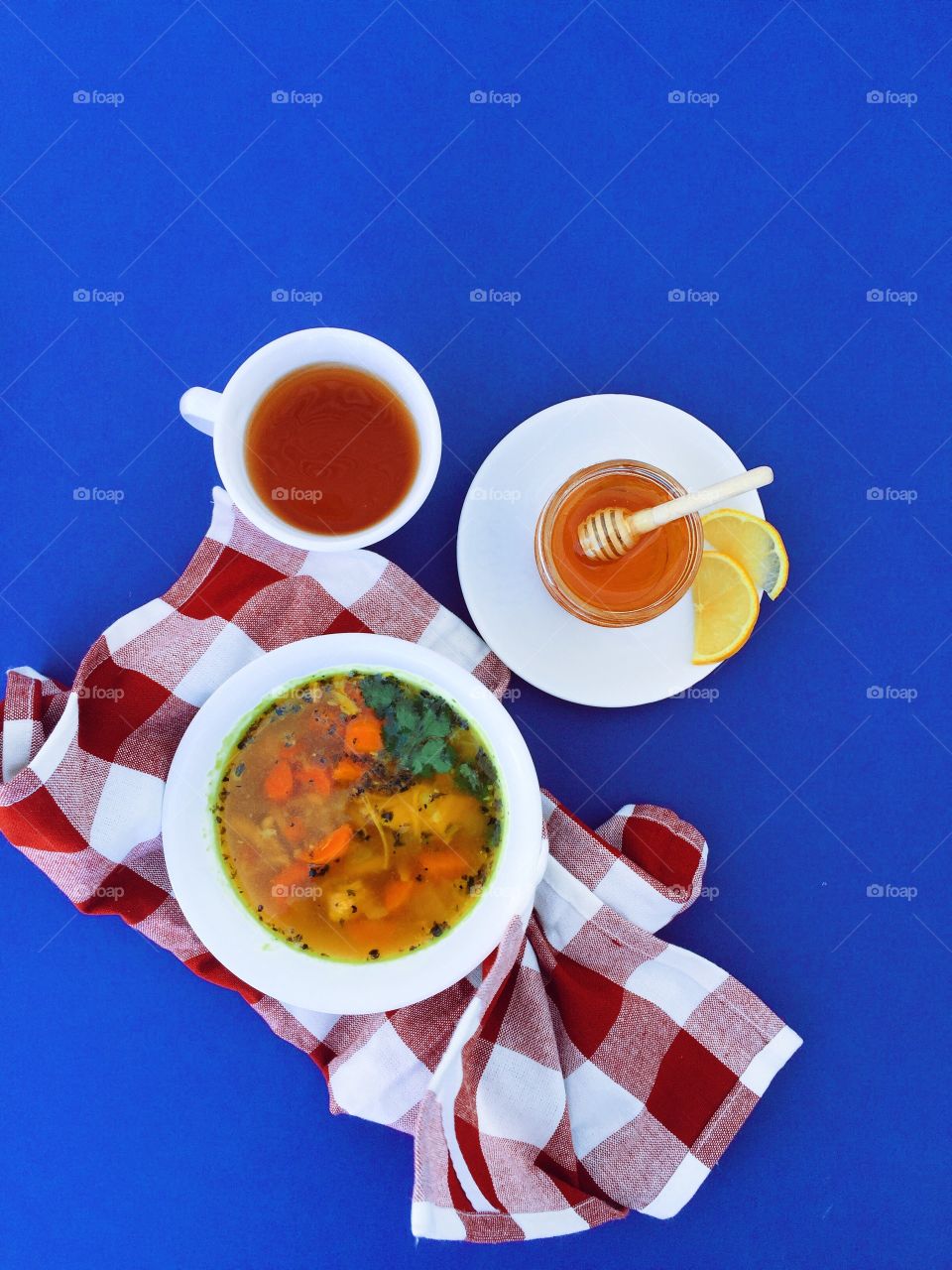 High angle view of chicken soup against blue backgroun