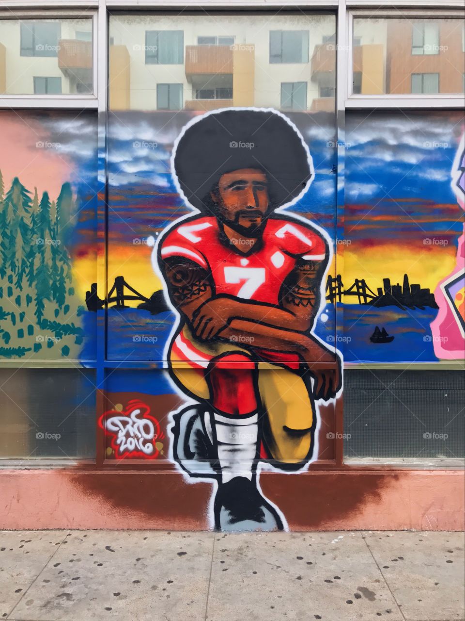 A graffiti mural of San Francisco 49ers quarterback Colin Kaepernick taking a knee during the National Anthem.