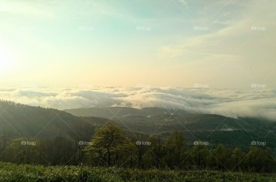 Mountain views overlooking valleys filled with fog.
