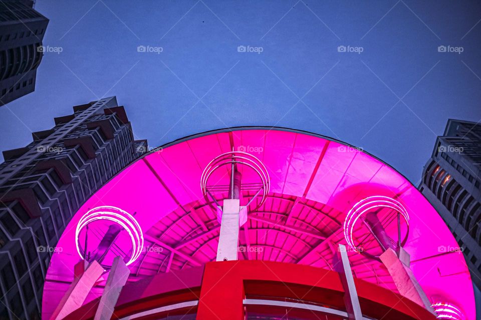 brightly lit building at the street looking up