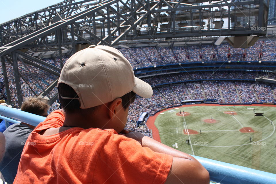 Boy watching baseball game