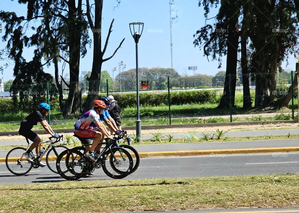 Cyclists enjoying the ride on a Sunday with friends on a bright,  sunny day.