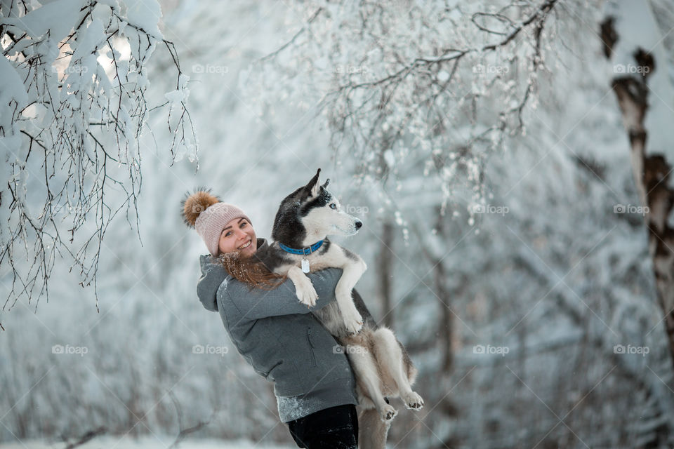 Walking with husky in winter park