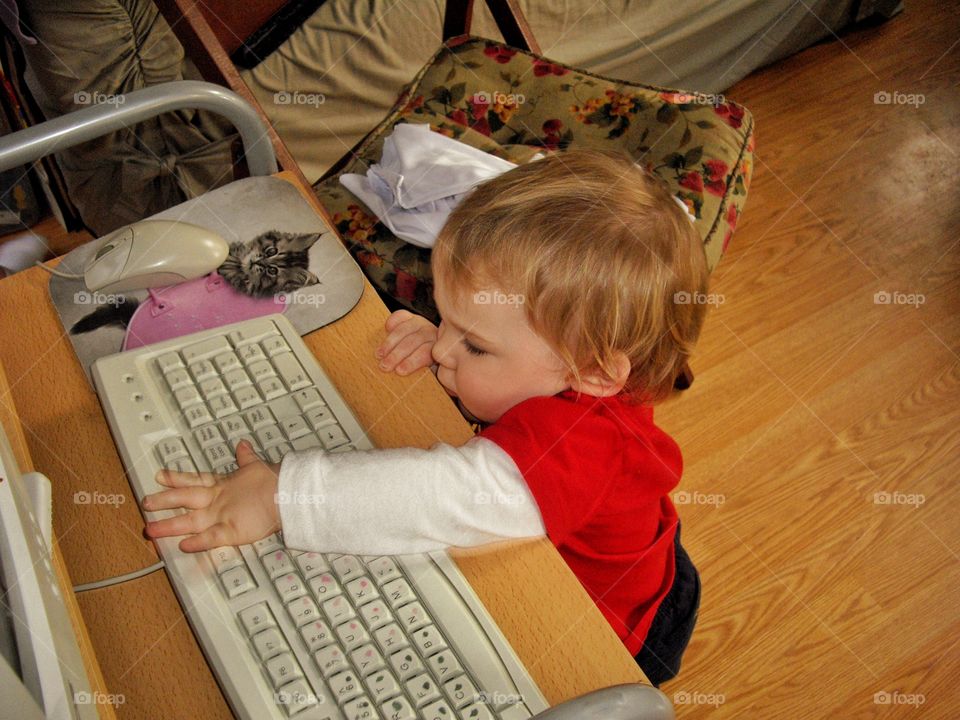 Toddler Playing With A Computer
