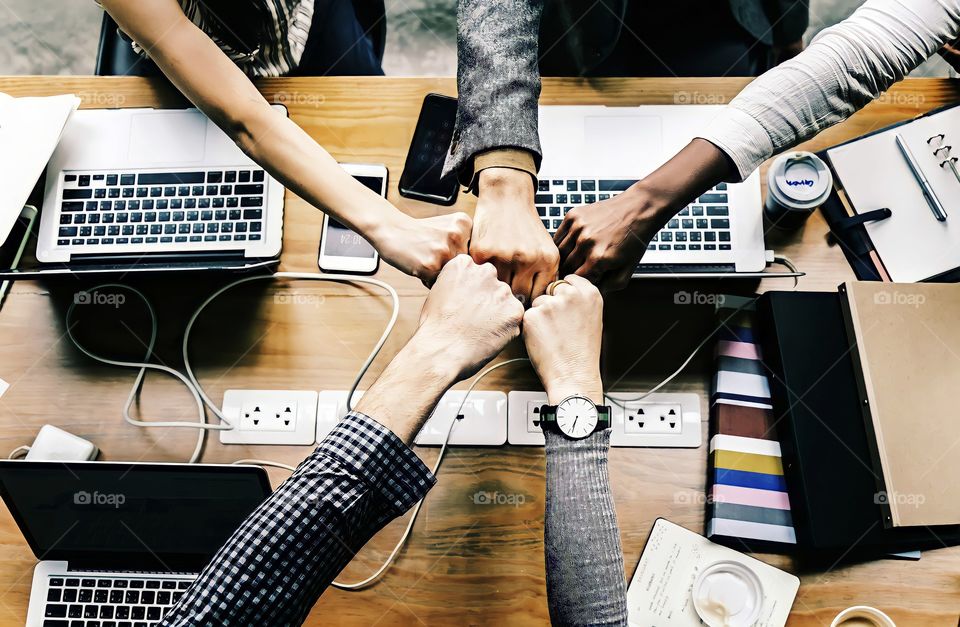 A business team giving Fist Bump in agreement across laptops.
A business team giving Fist Bump in agreement after a successful meeting.