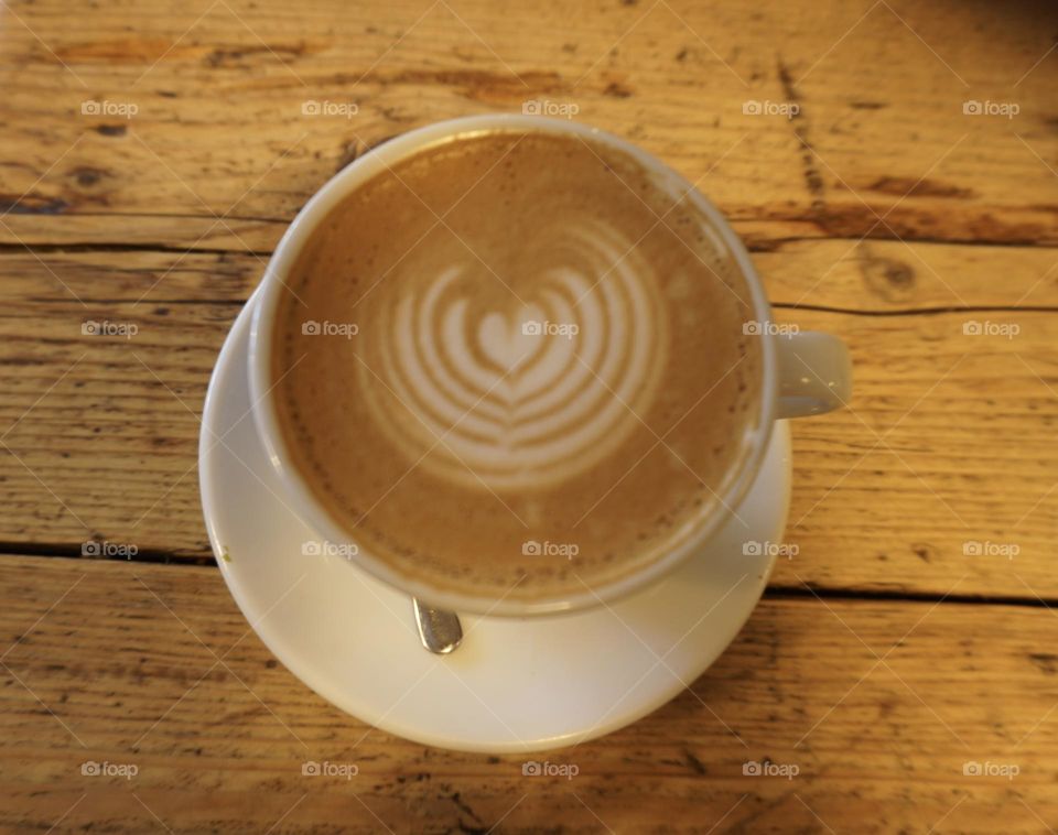 Coffee cup with a loveheart made from the cream 