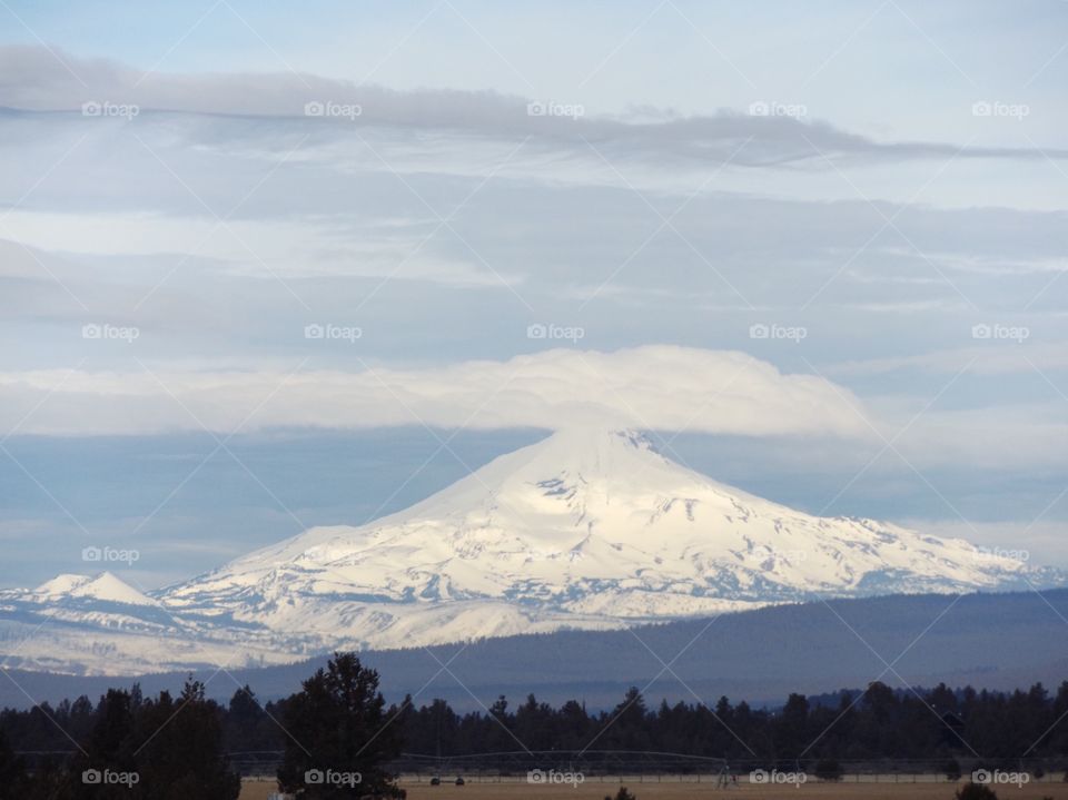 Snowcapped mountain peak with forest