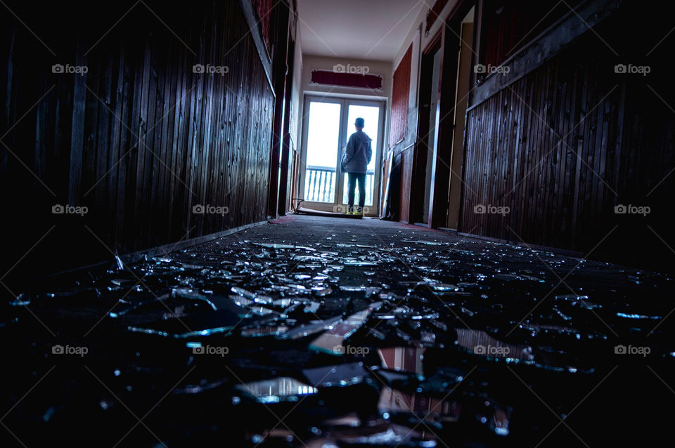 man standing in the door in abandoned place