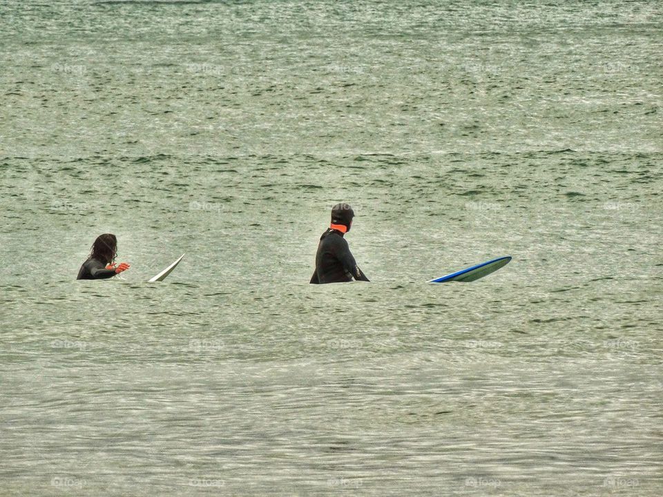 Two Surfers Waiting For A Wave. Waiting To Catch A Wave