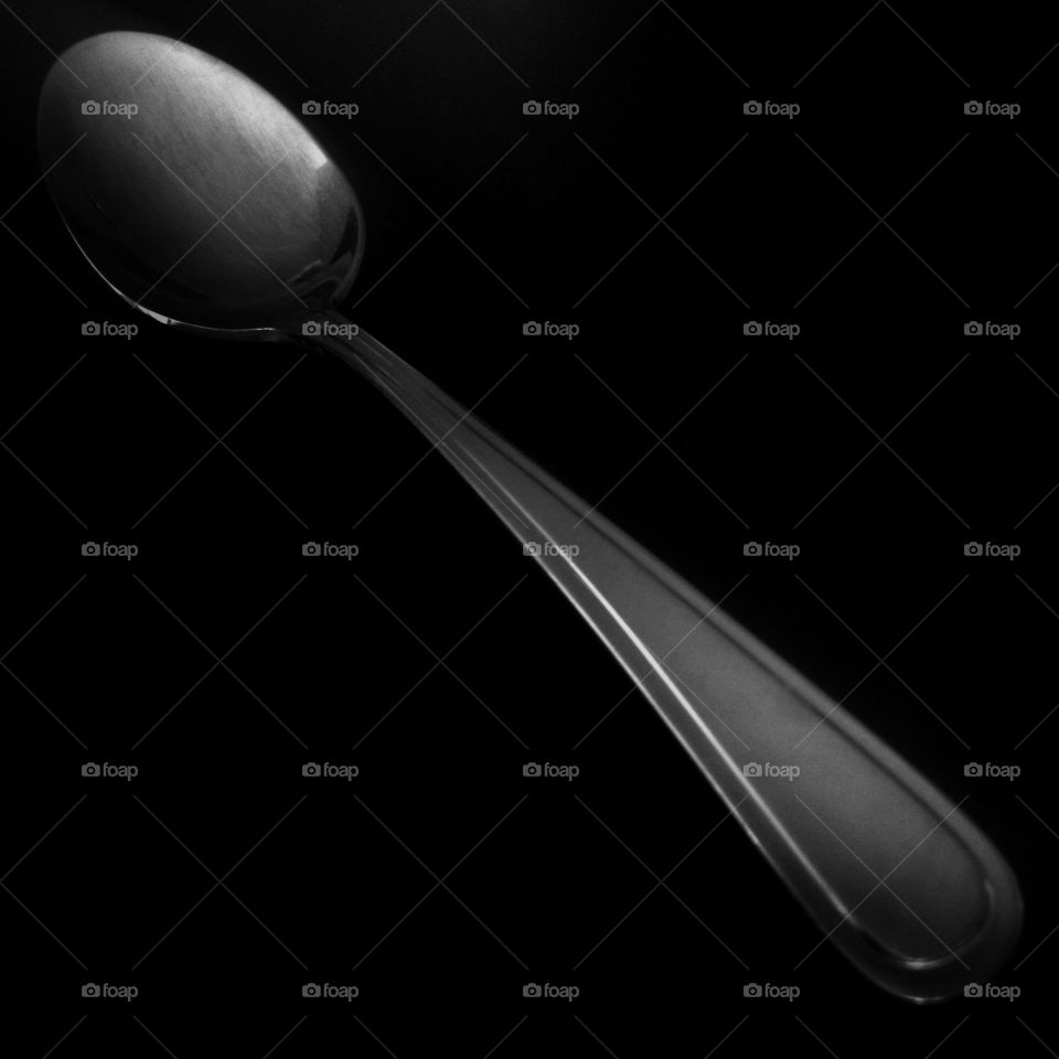 A spoon in a black and white square shot