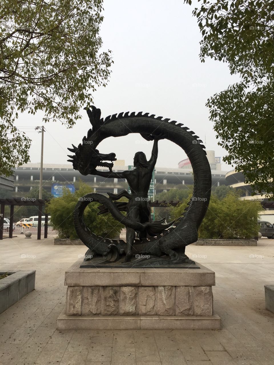 A statue of a man fighting a dragon