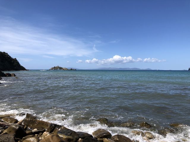 Rocks and stones beach and blue sea and sky 