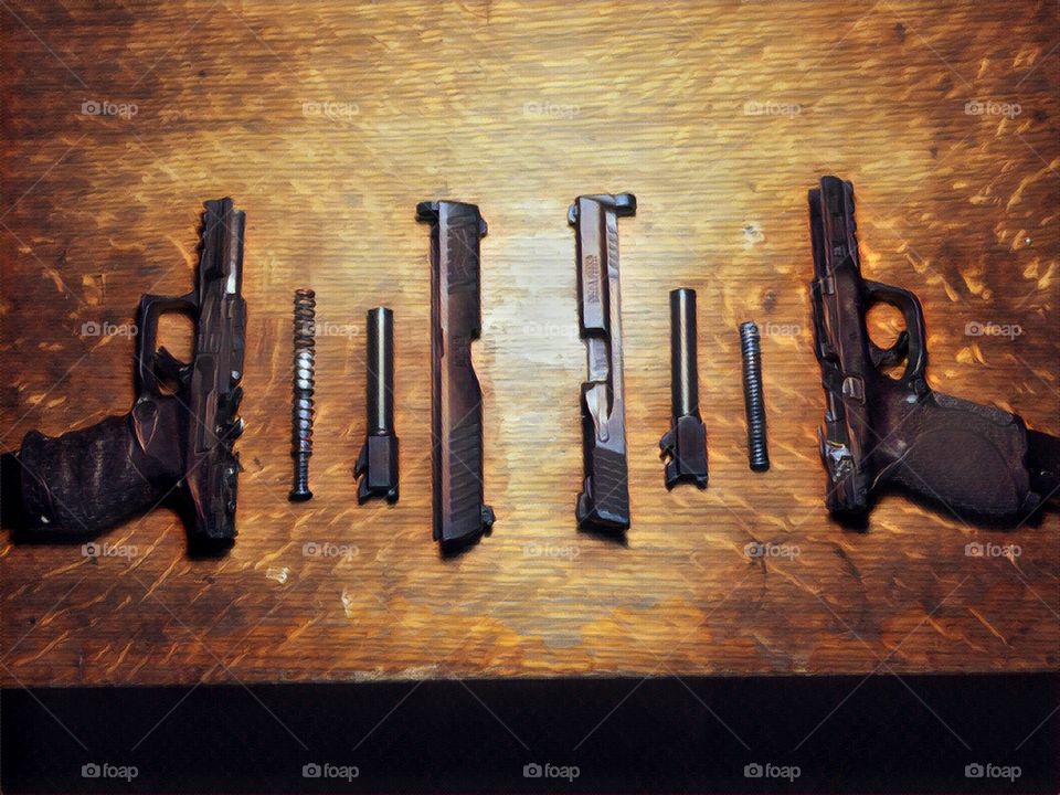 Walther PPQ and Smith & Wesson M&P 2.0 both 9mm on old wooden table