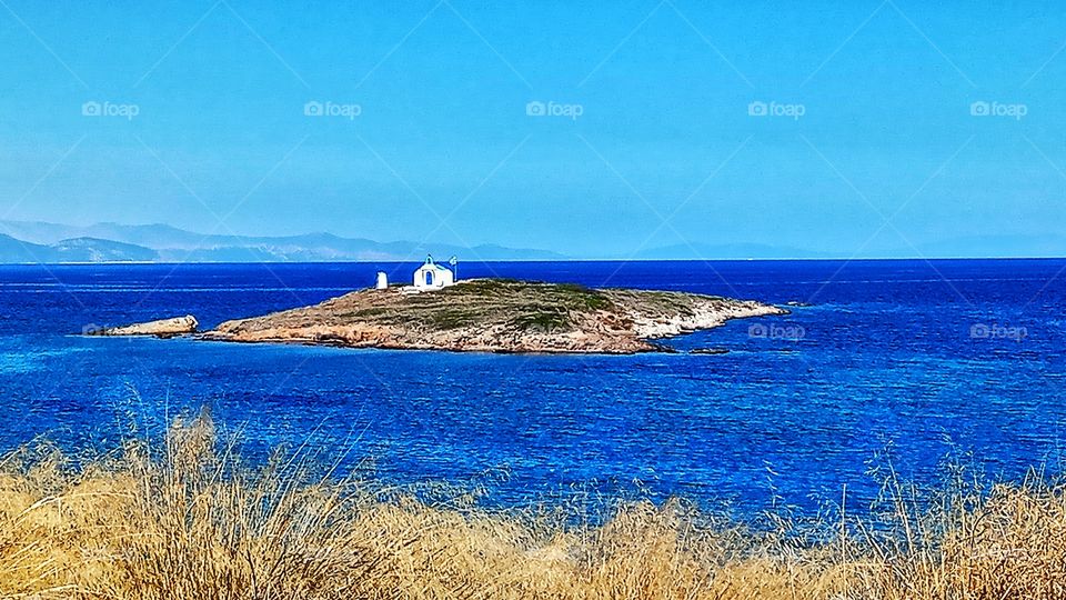 A little island with a little church into the big blue sea...Athens,Greece