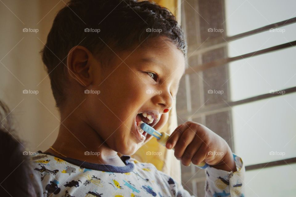 little baby brushing his teeth