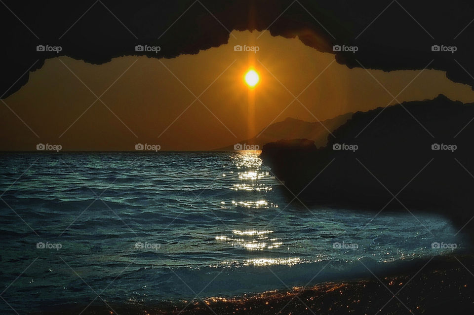 Silhouette of cliff during sunset