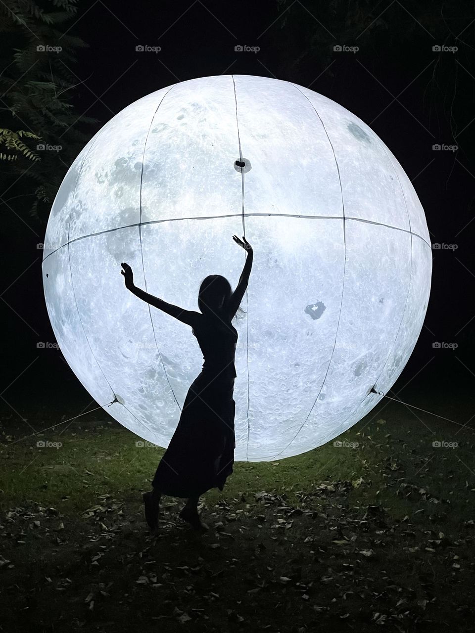 Woman Dancing in Front of the Art Installation Moon