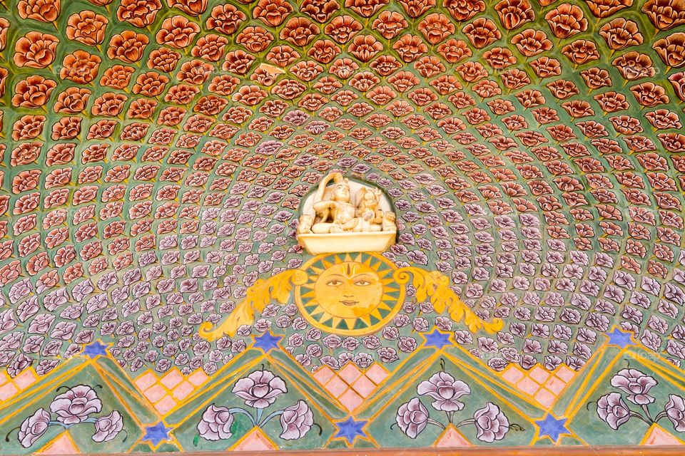 Decoration on top of he door. Colorful decoration on top of the door in India. Flower pattern surrounding sun. Hand painted 