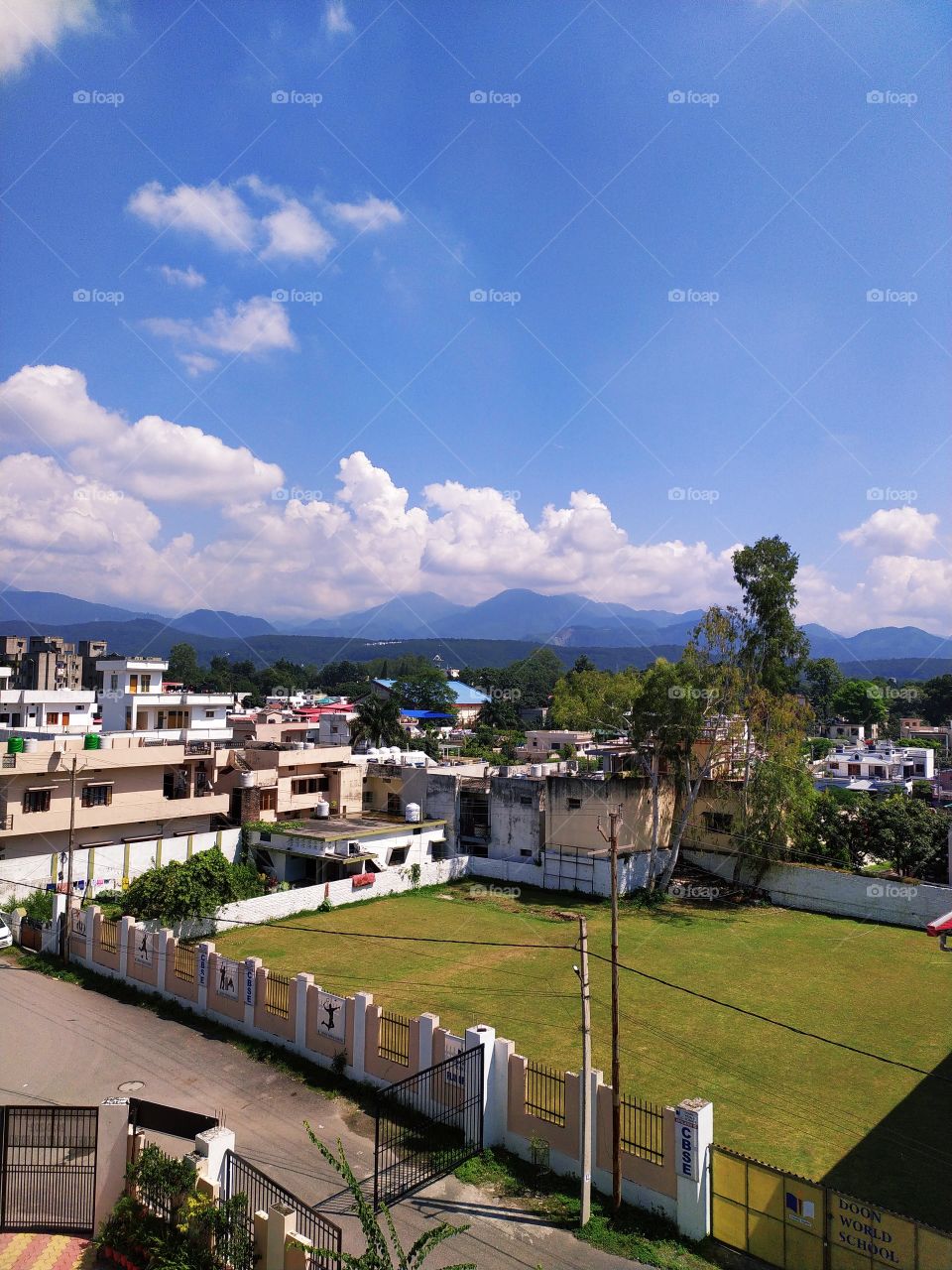 Beautiful autumn afternoon in the Himalayan  foothills. Mussoorie hills on the backdrop with a blue sky above