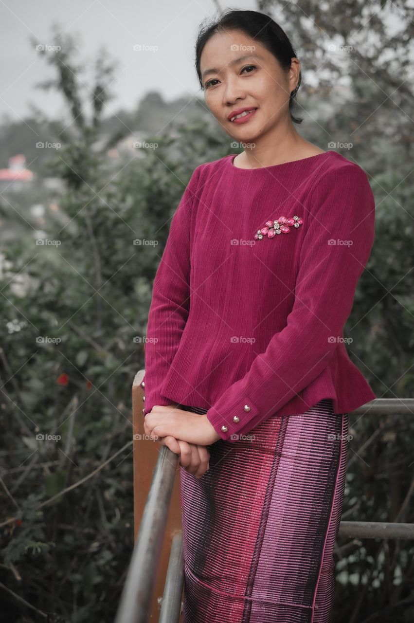 A mother of two in her ethnic wear, adorning a traditional sarong.