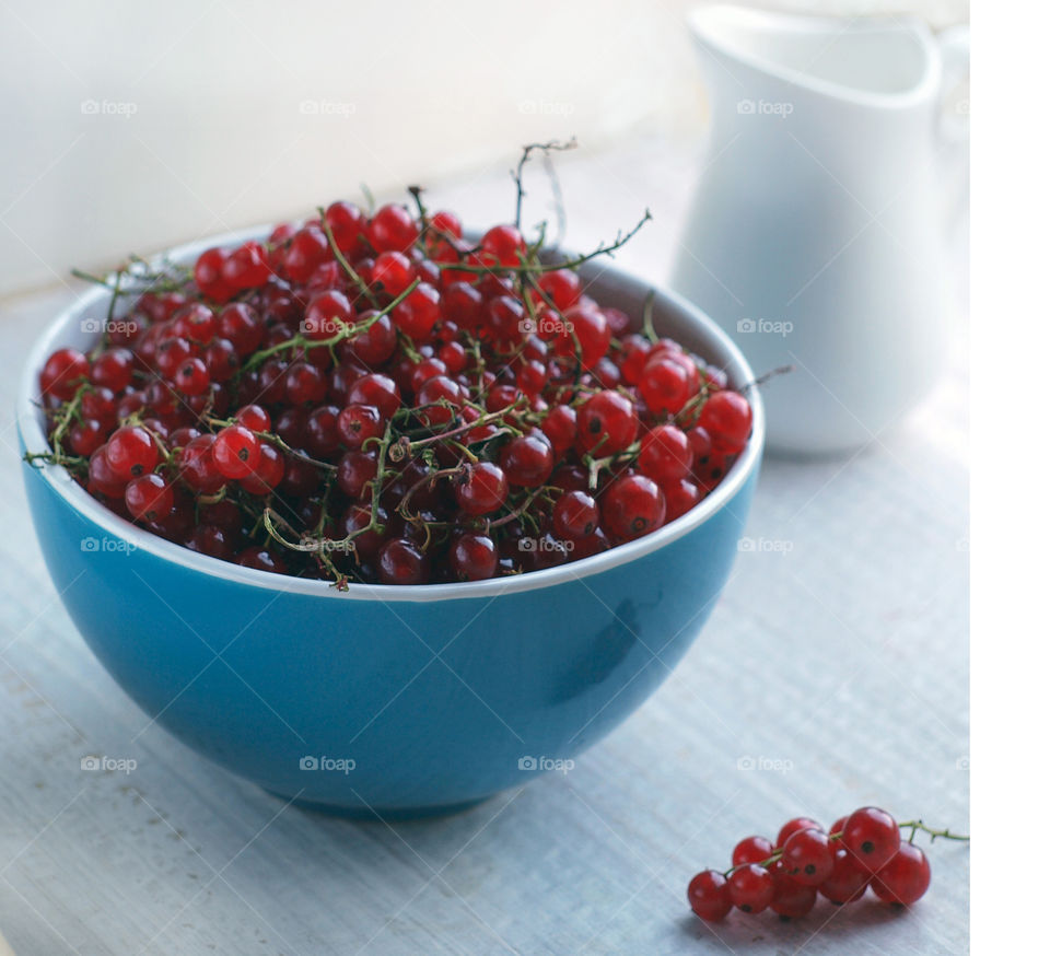 Red currant on blue bowl