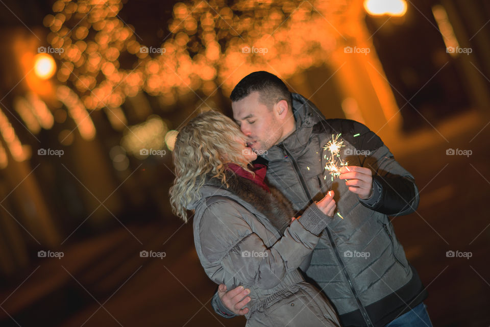 Happy couple on Christmas lights background