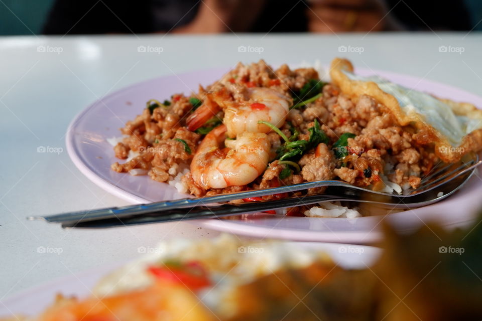 Rice topped with stir-fried pork and basil and shrimp