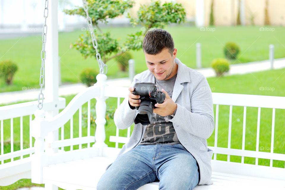 Handsome man holding camera