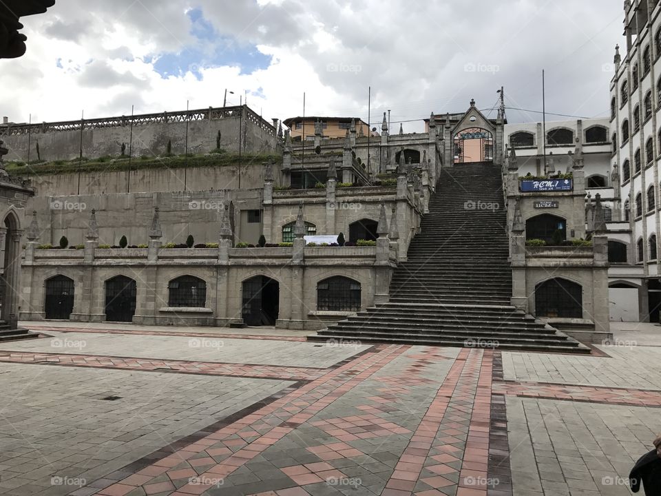 Courtyard in Ecuador’s capital city Quito on a cloudy day with spots of blue sky