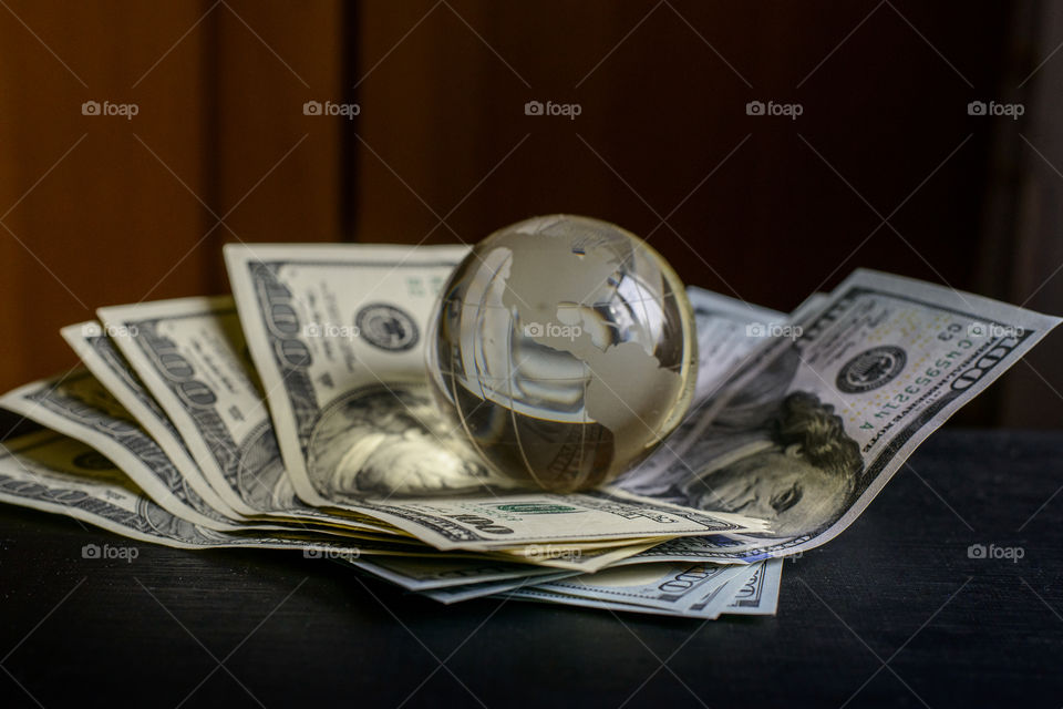 transparent globe on dollars