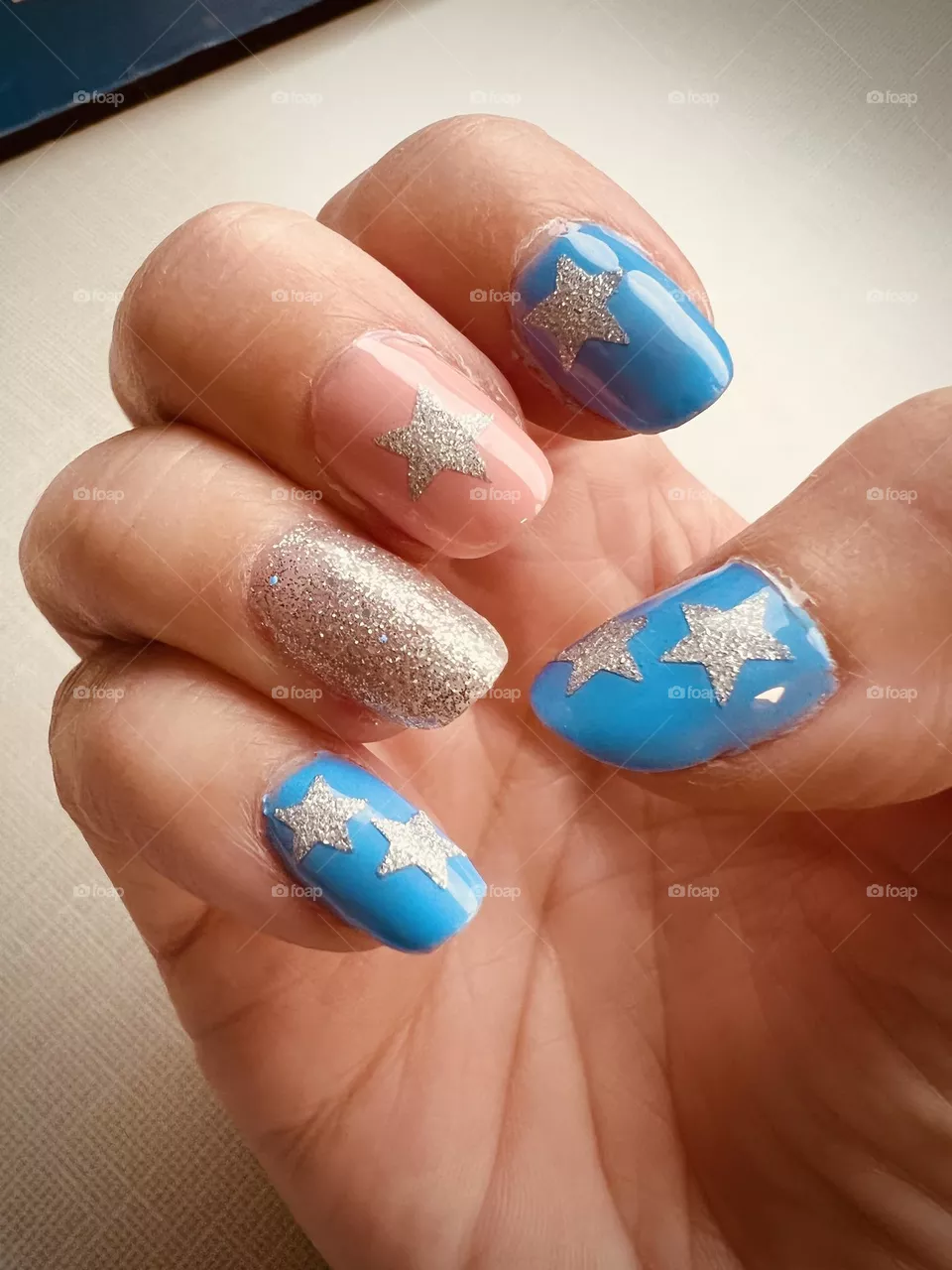 Pretty peach, blue and sparkly silver gel nail polish manicure 