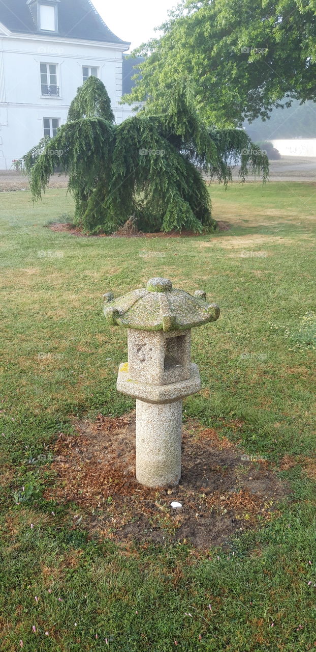 japanese stone lantern in a garden from normandy
