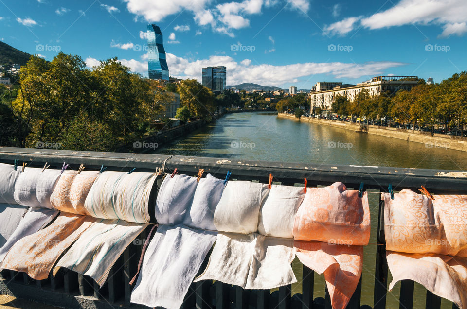 Embroidery, scarves and laundry for sale on the railing