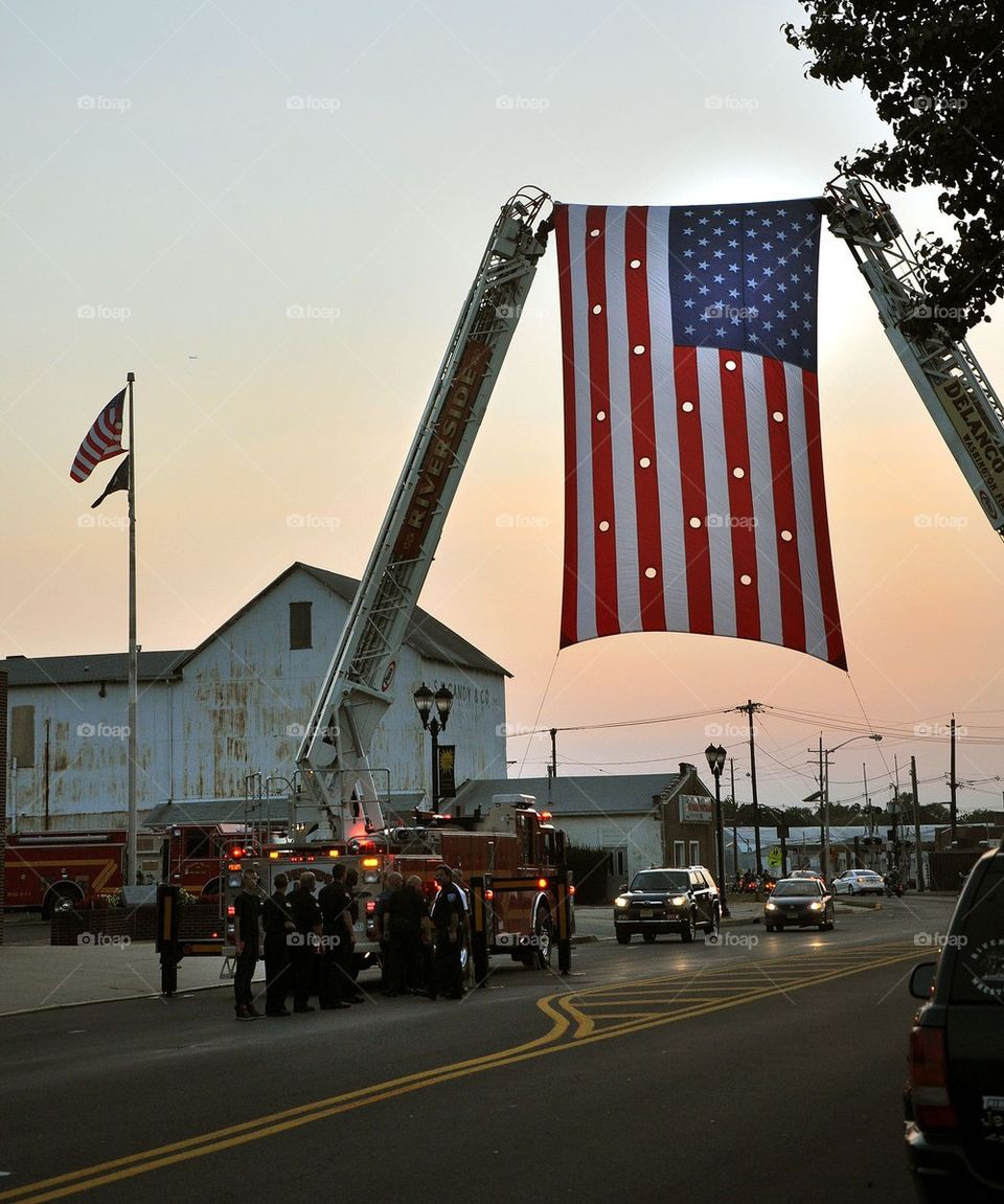 Large American flag raised at sunset