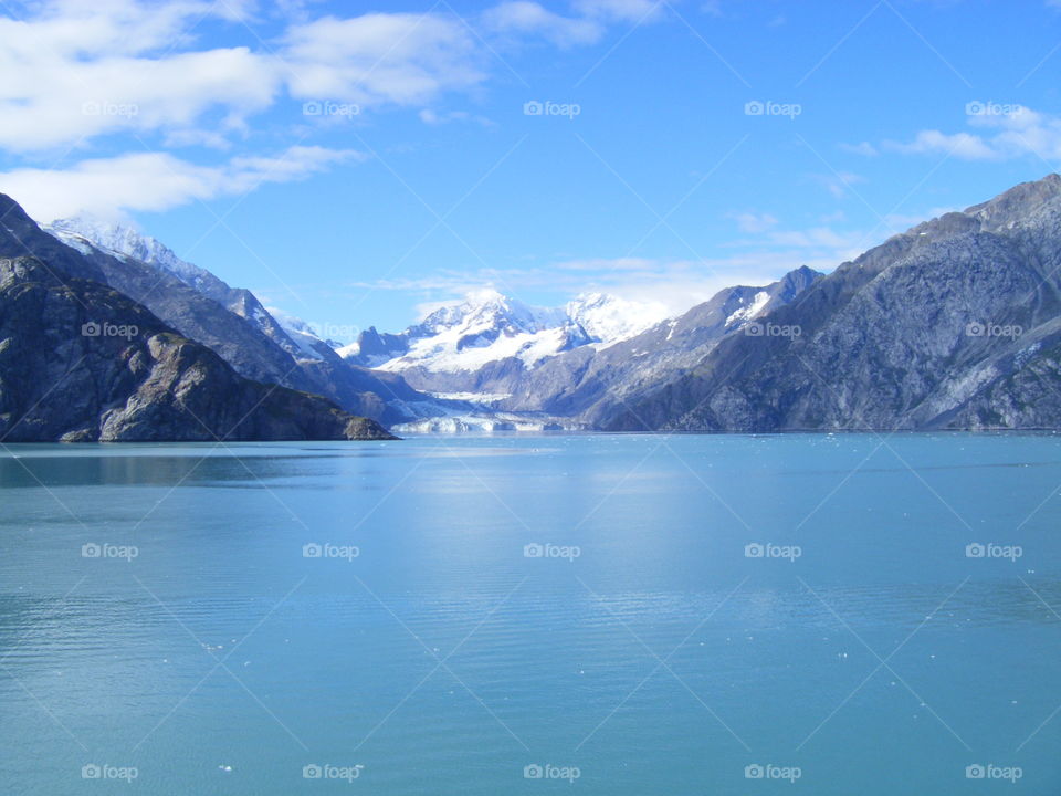 Stunning mother nature, bright sunny day view of glaciers and mountains from cruise ship traveling in Alaska