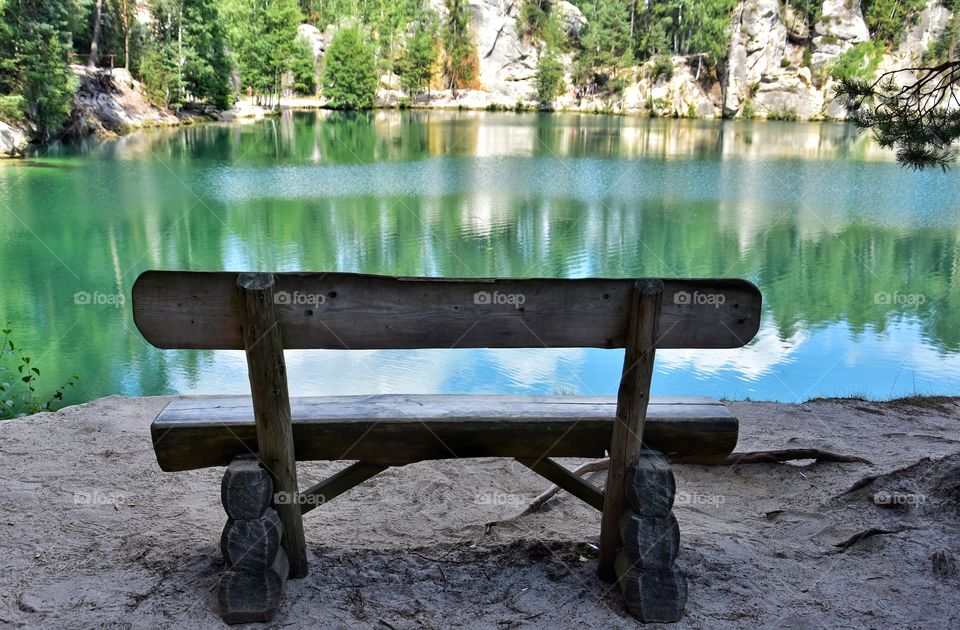 wooden bench at the lake in adrspach national park in Czech republic