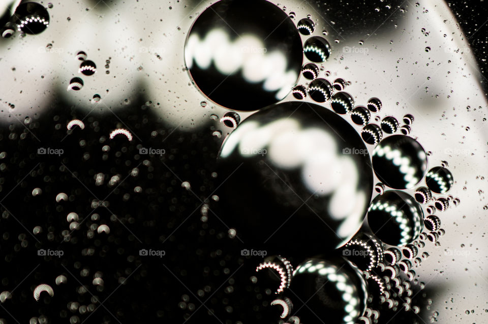 Small bubbles of vegetable oil in water close-up.