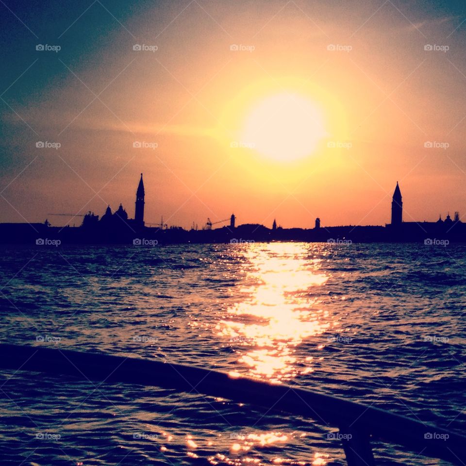 Sun goes down . Sunset in Venice