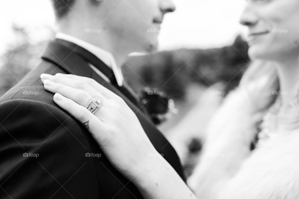 Black and White bride and groom looking at each other in love photo with visible wedding ring
