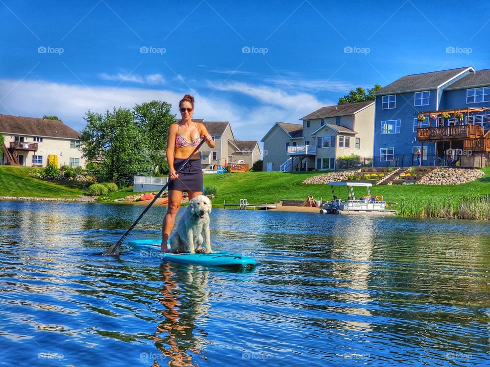 woman paddling with dog