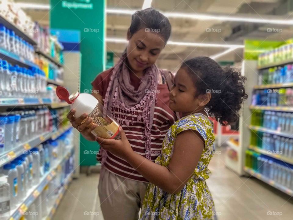 mother & daughter doing shopping.