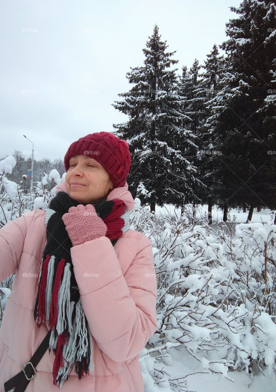 sweater weather girl portrait, walking in snowy park winter time