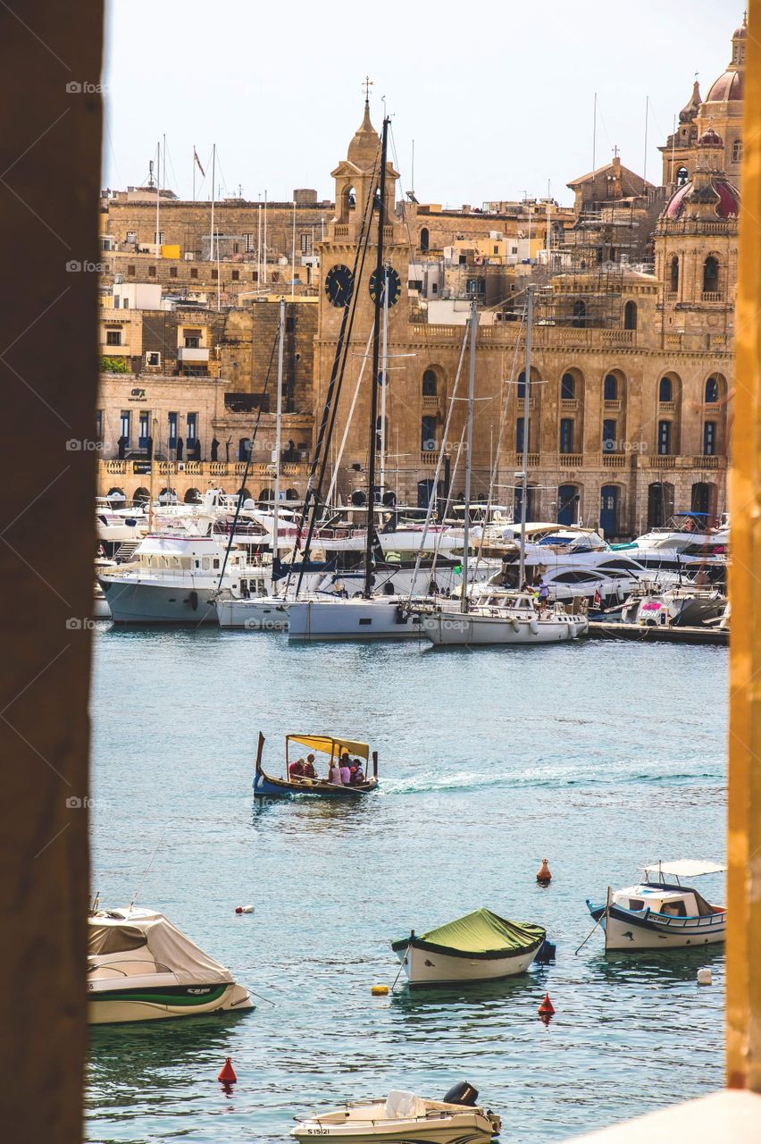 The beautiful Mediterranean sea framed by the walls of the city of Isla, in Malta. 
