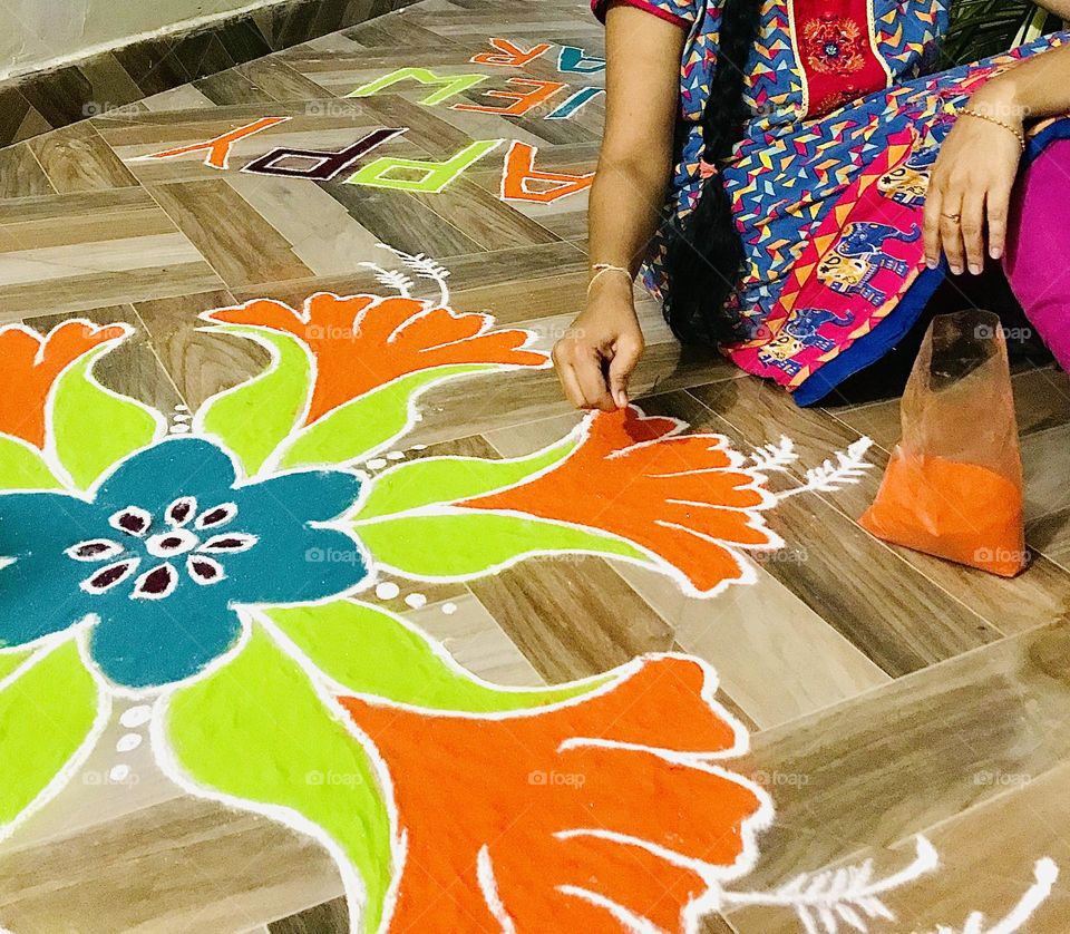 Indian Rangoli design made with powders and colours ,it’s a tradition to draw designs in front of every house in the occasion of festivals.